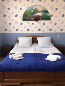 a bedroom with a bed with two towels on it at Max Hotel Gogi Alibegashvili in Kazbegi