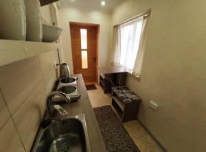 a small kitchen with a sink and a window at садиба Пан Коцький in Kosiv