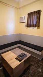 a room with a coffee table and a window at ParmView Inn in Legazpi