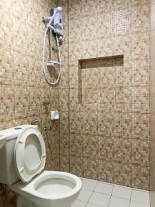 a bathroom with a toilet and a shower at ParmView Inn in Legazpi