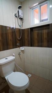 a bathroom with a toilet and a shower at ParmView Inn in Legazpi
