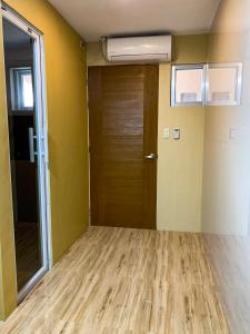 an empty room with a door and a window at ParmView Inn in Legazpi