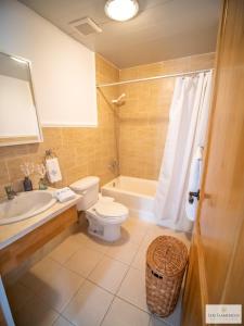 a bathroom with a toilet and a tub and a sink at Los Flamencos Aparthotel Beach Club in Bayahibe