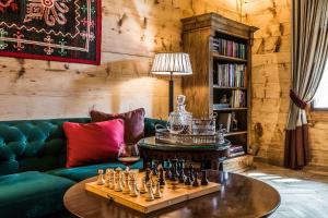 a living room with a chess game on a table at Willa Elżbiecina Luxury Residence & SPA in Zakopane