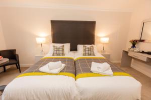 מיטה או מיטות בחדר ב-Dalkeith ApartHotel
