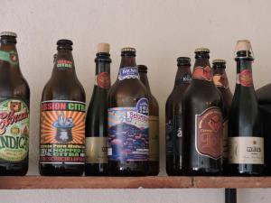 a row of beer bottles sitting on a shelf at Casa Rô in Tiradentes