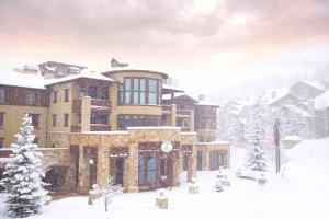 a large building in the snow with snow covered trees at The Chateaux Deer Valley in Park City