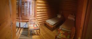 a small room with a bed and a chair in a cabin at Pankkotupa 66 "13B" in Savonlinna