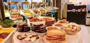 a buffet filled with different types of food on a table at Jumbo Hotel in Chişinău