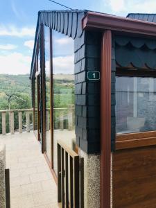 a balcony of a house with a large window at "Casa Do Avô Patrício" Mountain Experience in Parada