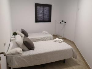 a room with two beds and a window on the wall at Apartamento IFAE 3 in Guía de Isora