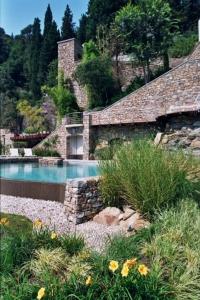 a house with a swimming pool next to a building at Eden Rock Resort in Florence