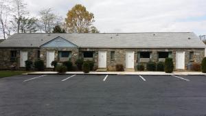 a building with a parking lot in front of it at Rock Haven Motel in Asheville