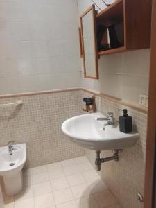 a bathroom with a sink and a toilet at La terrazza di Maja in Chieti