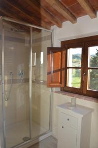 baño con ducha, lavabo y ventana en Le Bozze "Il Frantoio" con piscina, Wi-Fi, posto auto, en Castagneto Carducci