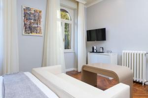 A television and/or entertainment centre at Villa Natalia Luxury Rooms