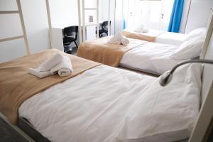 Una cama o camas en una habitación de AM Hostel