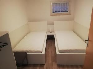 HarsumにあるAppartement Borsumの窓付きの小さな部屋のベッド2台