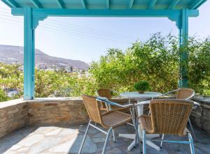 a table and chairs on a patio with a view at Ragousis Apartments in Parikia