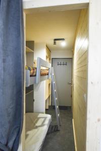 a small room with bunk beds and a ladder at Studio 4 personnes fraichement rénové au pied des pistes à Valfréjus in Valfréjus