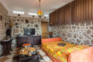 a bedroom with a bed and a tv in it at Apartments Green Harmony in Mlini