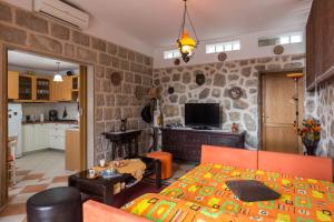 a living room with a bed and a kitchen at Apartments Green Harmony in Mlini