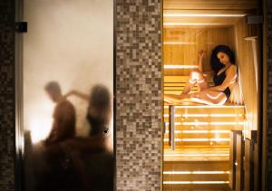 two pictures of a woman sitting in a sauna at Hotel Continental in Sorrento
