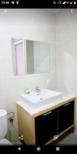 a bathroom with a sink and a mirror and a toilet at Menorca beach in Cala Galdana