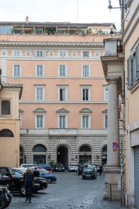 a large building with cars parked in front of it at House Santa Caterina in Rome