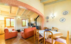 a living room with a table and a dining room at Finca Son Garreta in Campanet