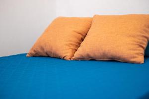 a close up of a bed with two pillows at Casa Triana in Vejer de la Frontera