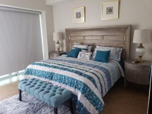 a bedroom with a large bed with a blue comforter at Big Luxury Condo - Zona Dorada in Mazatlán