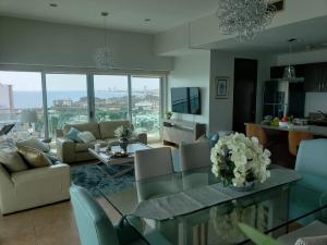 a living room with a couch and a table with chairs at Big Luxury Condo - Zona Dorada in Mazatlán