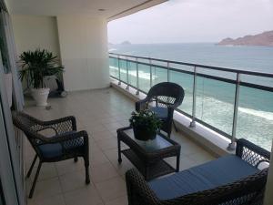 a balcony with chairs and a view of the ocean at Big Luxury Condo - Zona Dorada in Mazatlán