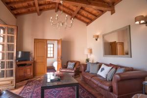 a living room with a couch and a table at La Maison in Villeneuve-de-Duras