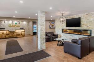a lobby with couches and a fireplace at Quality Inn & Suites in Bathurst