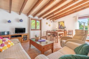 a living room with a couch and a table at La Sorteta De Cuxach in Pollença