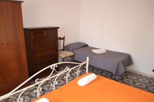 Ένα ή περισσότερα κρεβάτια σε δωμάτιο στο Appartamento 8 pax vicino spiaggia