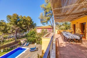 a patio with a table and chairs and a swimming pool at Green Bike in Santa Ponsa