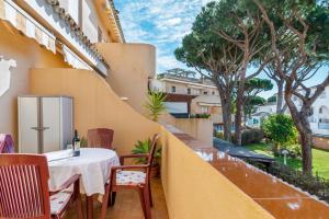 a balcony with a table and chairs on a building at Apartamento La Caracola in Chiclana de la Frontera