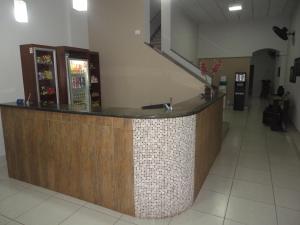 a lobby with a reception counter in a building at Grande Hotel Araçatuba in Araçatuba