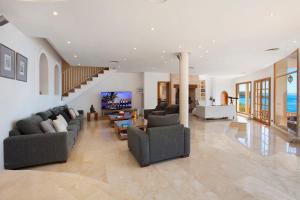 a large living room with couches and a tv at Villa Juan Carlos in Cala Vinyes