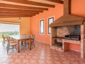 a dining room with a table and a fireplace at Ses Mires in Cala Santanyi