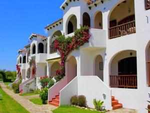 a building with flowers on the side of it at Girasol Garden Superior 2-c in Son Bou