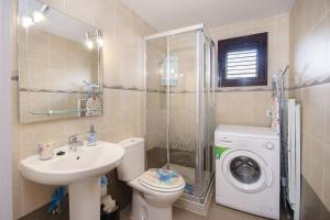 a bathroom with a toilet sink and a washing machine at Apartamento Los Morales in Puerto del Carmen +17 photos