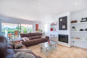 a living room with a couch and a fireplace at Abatzer in Ciutadella