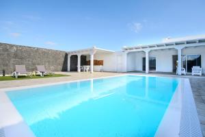 a large blue swimming pool in a house at Casa Mercedes in Yaiza