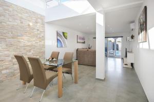 a dining room with a glass table and chairs at Casa Mercedes in Yaiza