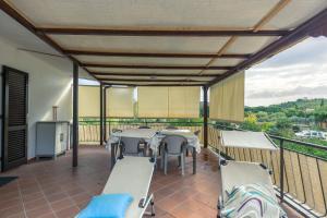 a patio with a table and chairs on a balcony at Casa Lucia Marina di Campo in Campo nell'Elba