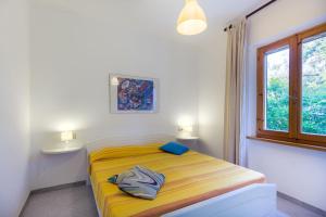 מיטה או מיטות בחדר ב-Casa Lucia Marina di Campo